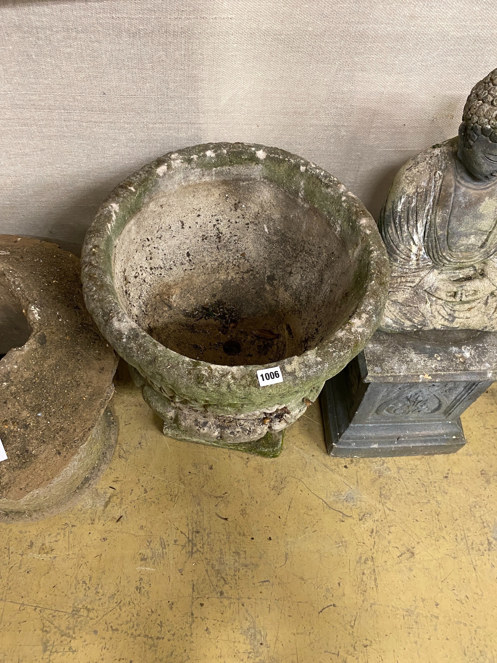 A circular reconstituted stone garden planter, diameter 47cm, height 60cm